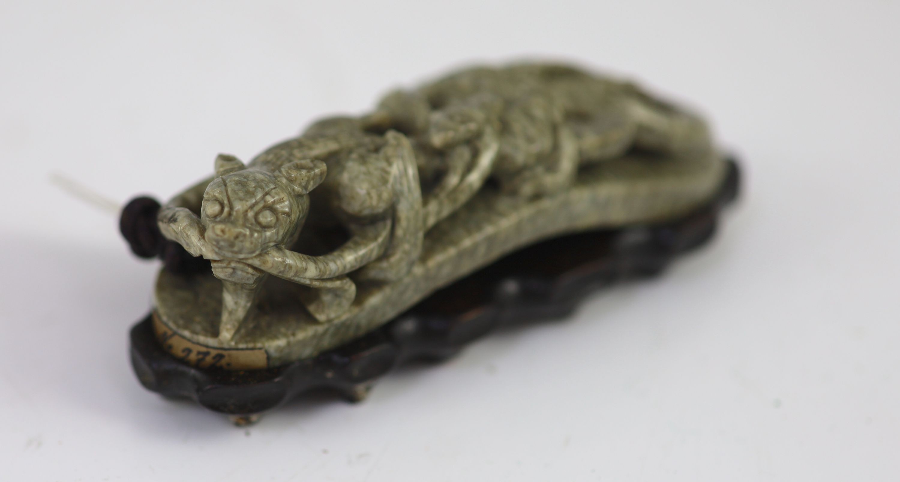 A Chinese ‘chicken bone’ jade carving, 17th/18th century 11 cm long including wood stand